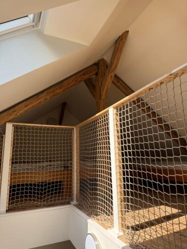 a cage in a room with a ceiling at Tkalcovna U Zlatého potoka in Dobřany