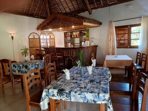 a dining room with two tables and chairs at Amoron'ny Ala in Andasibe