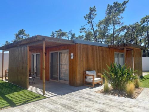 a wooden shed with a chair and a table at 818 Centro Náutico Bungalows in Vila Real de Santo António