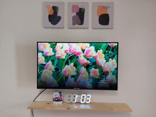 a flat screen tv sitting on top of a table at Chill Spot Staycation in Pasig in Manila