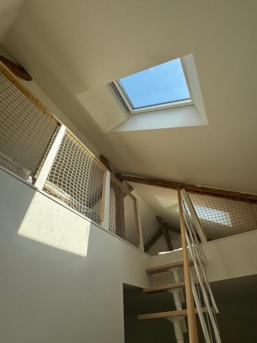a staircase in a room with a skylight at Tkalcovna U Zlatého potoka in Dobřany