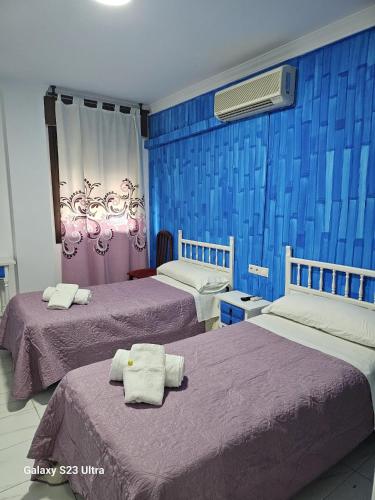 Postel nebo postele na pokoji v ubytování Hotel Virgen de los Reyes