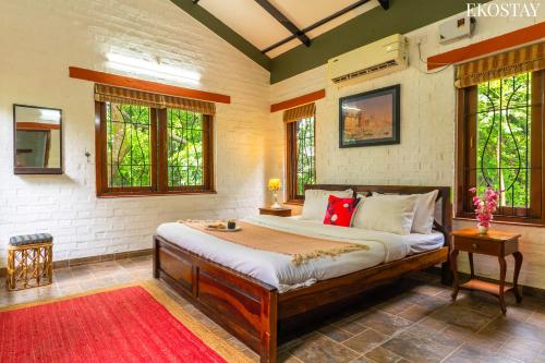 a bedroom with a large bed in a room at EKOSTAY- Caribbean Villa in Panvel