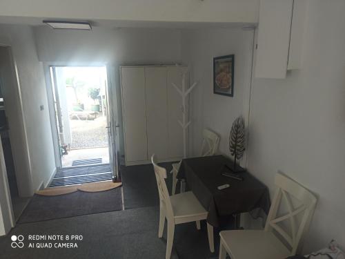 a dining room with a table and chairs and a door at Hotel Adriana in Aschaffenburg