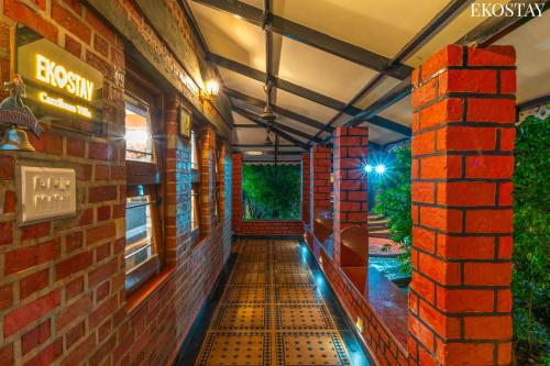 an empty hallway of a brick building at night at EKOSTAY- Caribbean Villa in Panvel