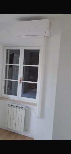 a white window in a white room with a radiator at casa ortensia in Formia
