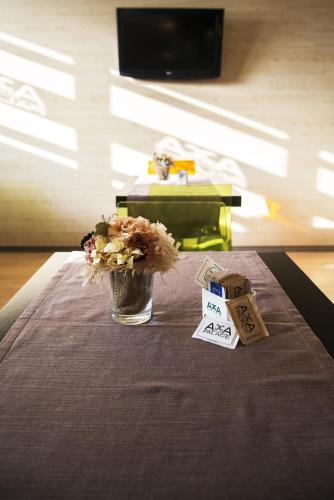 a table with a vase of flowers on a table at Acca Palace AA Hotels in Milan