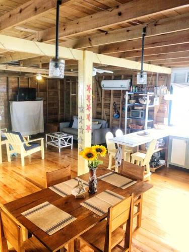 a dining room with a wooden table and chairs at Oceanfront, Quiete and Convenient Location in Bocas del Toro