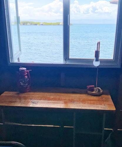 a window with a view of the ocean in a room at Oceanfront, Quiete and Convenient Location in Bocas del Toro