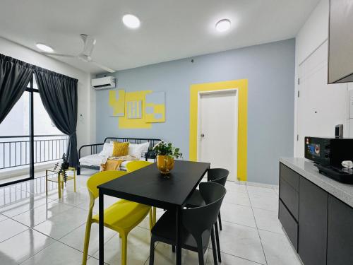 a kitchen and dining room with a table and yellow chairs at New The Sun Homestay at Sg Nibong nearby Queensbay or PISA or FTZ Bayan Lepas HENG in Bayan Lepas