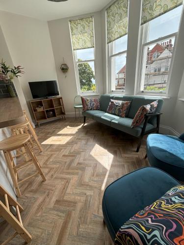 a living room with a couch and a tv at Holywell Stays in Old Town