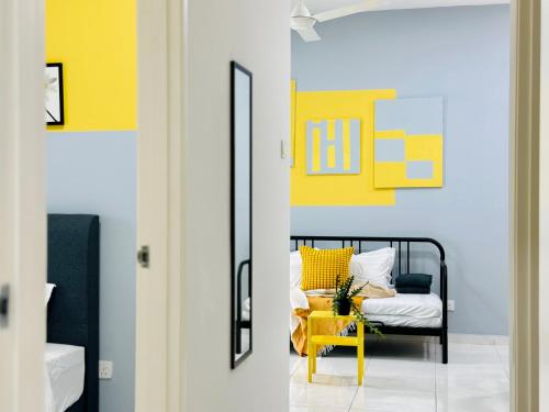 a room with a bed and a yellow chair at New The Sun Homestay at Sg Nibong nearby Queensbay or PISA or FTZ Bayan Lepas HENG in Bayan Lepas