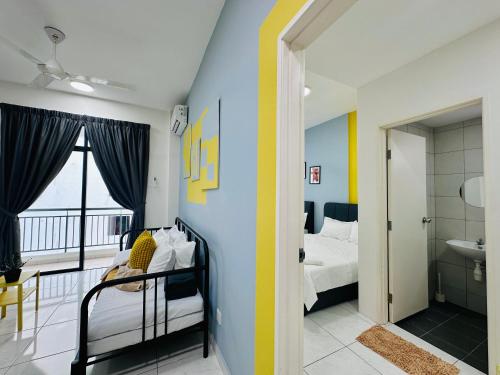 a bedroom with blue and yellow walls and a bathroom at New The Sun Homestay at Sg Nibong nearby Queensbay or PISA or FTZ Bayan Lepas HENG in Bayan Lepas