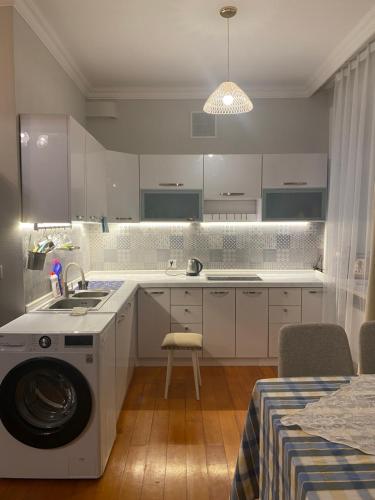 a kitchen with a washing machine in the middle of it at Cozy apartment 65 in the city heart in Ulaanbaatar