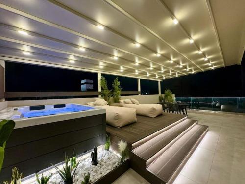a living room with a hot tub in the middle at BlueMotion - CityView in Piraeus