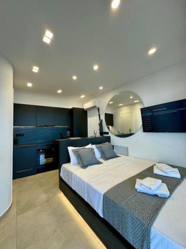 a bedroom with a large bed with blue cabinets at BlueMotion - CityView in Piraeus