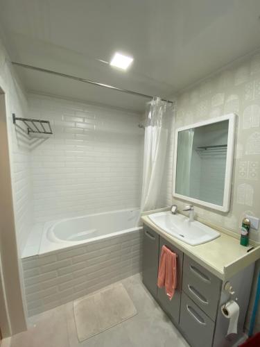 a bathroom with a sink and a bath tub at Cozy apartment 65 in the city heart in Ulaanbaatar
