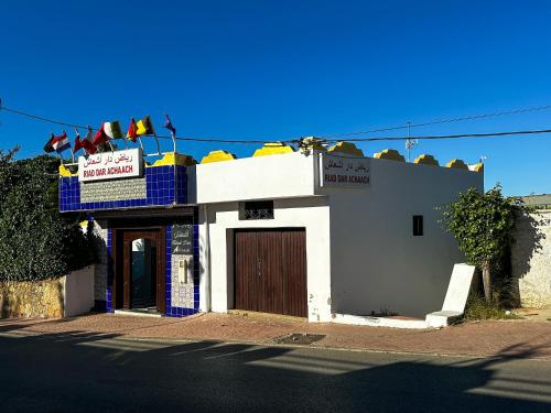 a building with a sign on the top of it at Riad Dar Achaach in Tetouan