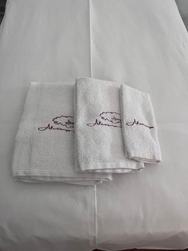 two towels sitting on top of a bed at Alentempo in Aldeia de Brescos