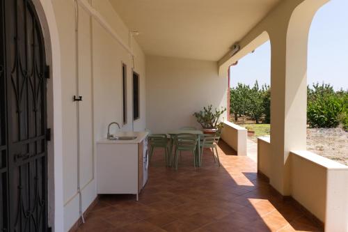 a hallway of a house with a table and chairs at Villa Mondonuovo in Mesagne