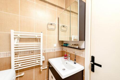 a bathroom with a sink and a mirror at Qbra House 2BR Central Apt Walk to Landmarks in Istanbul