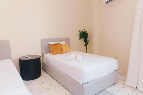 a bedroom with a white bed and a table at VIDA by Elegant Hospitality in Cairo