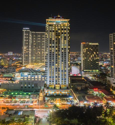 a city lit up at night with tall buildings at Havana Nha Trang Hotel in Nha Trang