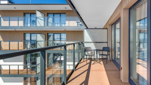 a balcony with a table and chairs on a building at Apartamenty Helski Brzeg in Hel