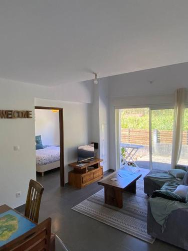 a living room with a couch and a table at Hortensia in La Plaine des Palmistes