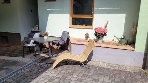 a patio with a table and chairs and a table and a table and chairs at Ferienwohnung Anderl in Hörmanns bei Weitra