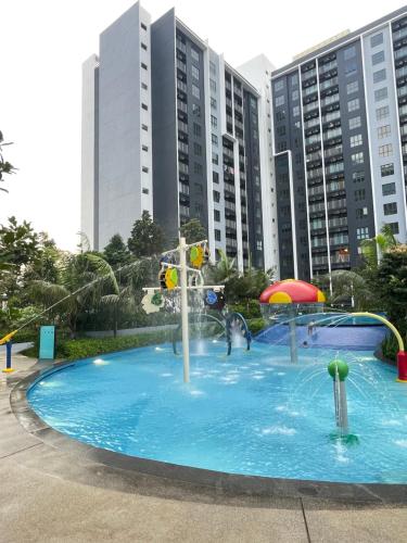 a large pool with a water park in a city at Mayabay Residences - Cove Inn in Pulau Kempas
