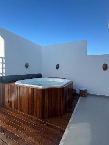 a hot tub in a room with a blue light at Sunny Kite House Prea in Prea
