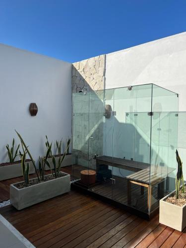 a glass shower with a table on a wooden deck at Sunny Kite House Prea in Prea