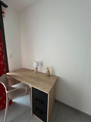 a wooden desk with a lamp on top of it at Résidence Le Carillon in Saint-André