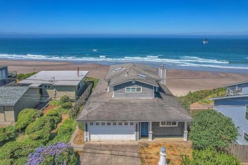 an aerial view of a house and the ocean at Roads End Light House in Lincoln City