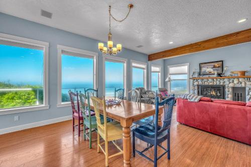 a dining room with a table and chairs and a couch at Roads End Light House in Lincoln City