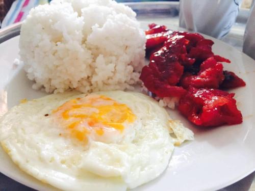 a plate of food with eggs and rice on a table at Emshienell Beach Resort and Event Place in Zambales