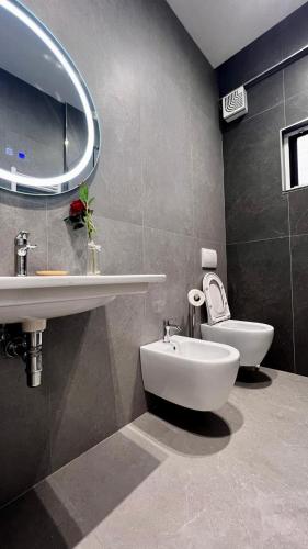 a bathroom with a sink and a toilet at Arvi Rooms in Lukovë