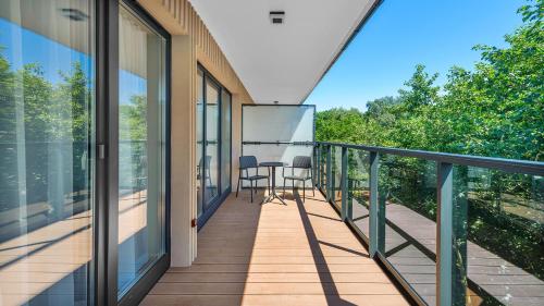 a balcony with a table and chairs on it at Apartamenty Helski Brzeg in Hel