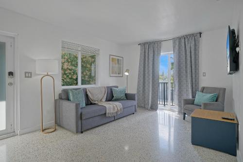a living room with a couch and two chairs at Elegant Wynwood Flats in Miami