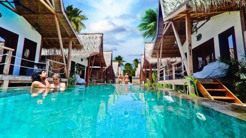 two people in the swimming pool at a resort at Kaleydo Villas in Gili Trawangan