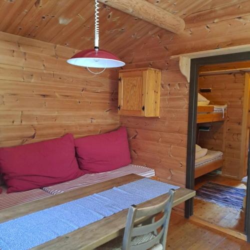 a room with a couch and a table in a log cabin at Lensmansgarden in Innfjorden