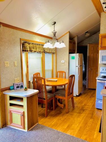 a kitchen and dining room with a table and chairs at Maggie Valley Cabin Rentals in Maggie Valley