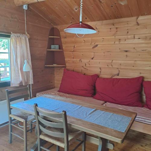 a dining room with a table and a couch at Lensmansgarden in Innfjorden
