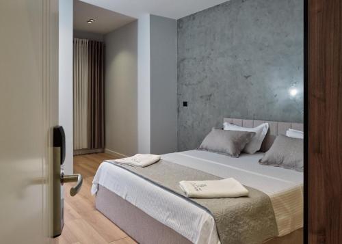 Postel nebo postele na pokoji v ubytování Montflux Hotel
