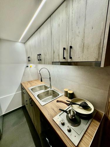 a small kitchen with a sink and a stove at Sophia Loft Luxury Stay with Parking in Athens