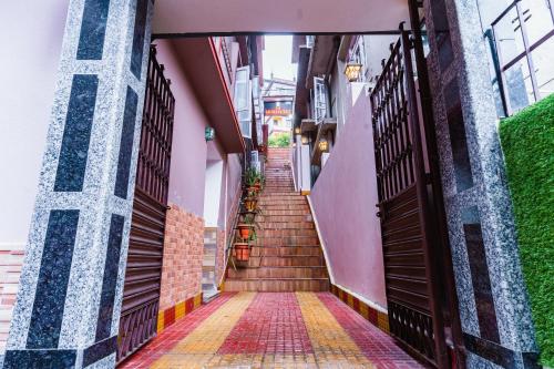 a stairway leading up to a building with a set of stairs at The Golden Retreat Hotel in Pelling in Pelling