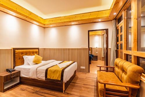 a hotel room with a bed and a bench at The Golden Retreat Hotel in Pelling in Pelling