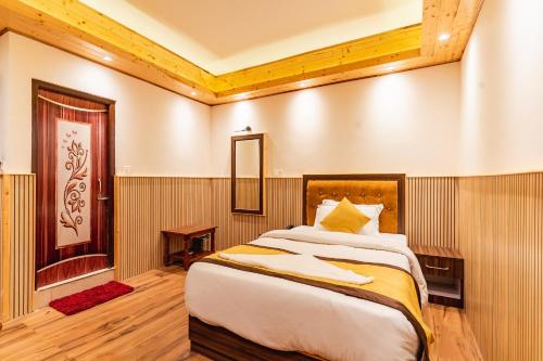 a bedroom with a large bed in a room at The Golden Retreat Hotel in Pelling in Pelling