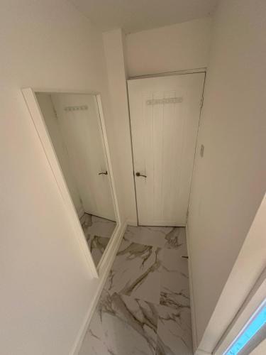 a room with two doors and a marble floor at The White House in Birmingham
